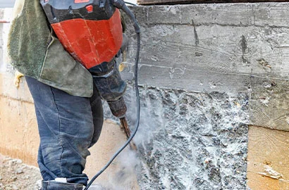 worker-with-jackhammer-construction-site-levels-concrete-wall-powerful-manual-industrial-equipment-difficult-construction-job_331695-3118